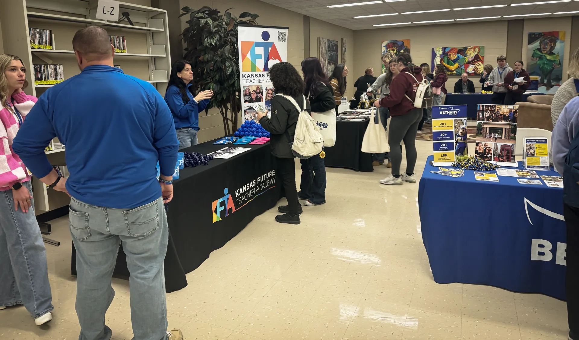Students looking at booths at a conference. 